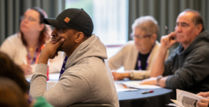 man in baseball cap at conference