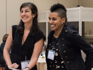 Two young people stand together smiling at the Vision Summit