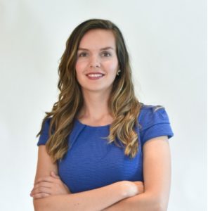 A young woman with long hair in a blue shirt