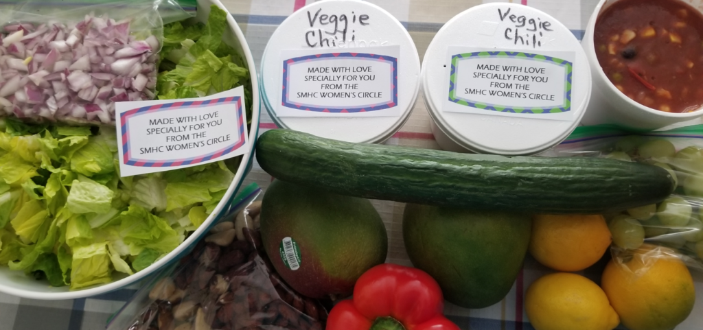 An array of fresh produce and containers of prepared food