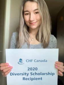 A person with long light hair holds up a sign that says "CHF Canada 2020 Diversity Scholarship recipient"