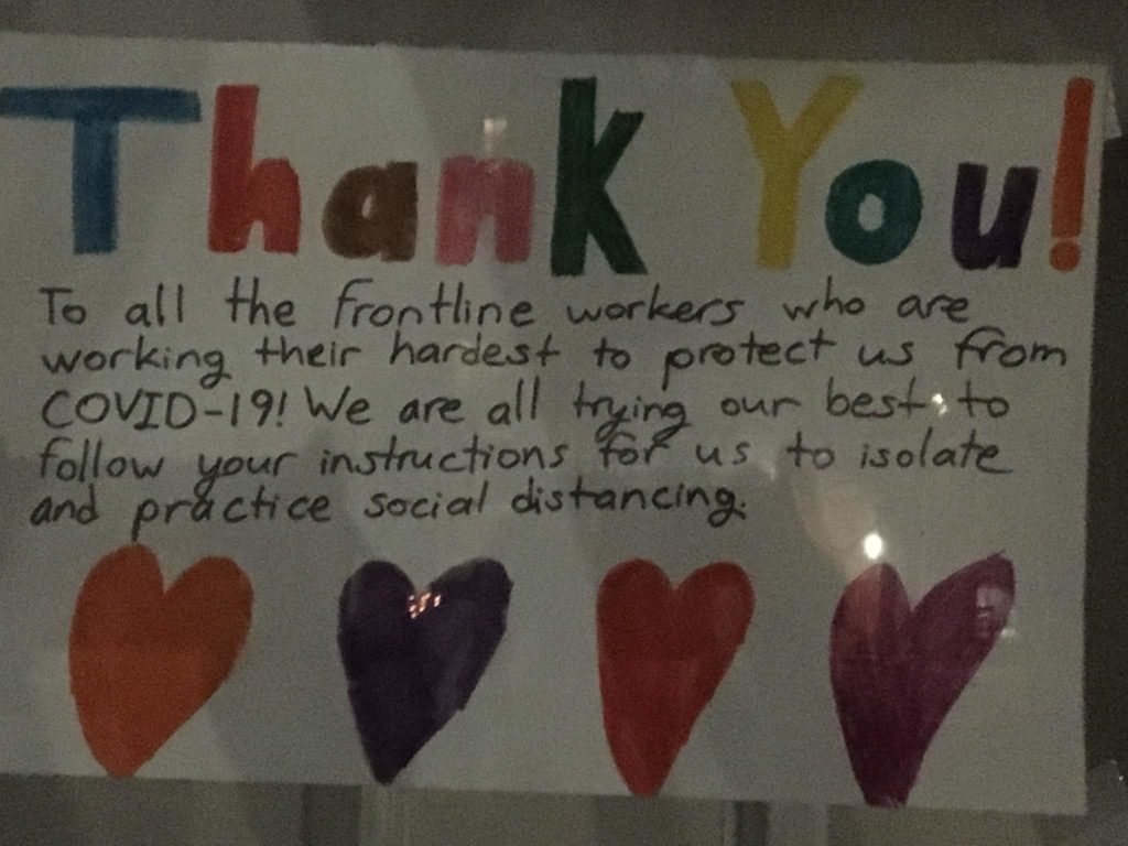 Handwritten sign, with hearts: "Thank you to all the frontline workers, who are working their hardest to protect us from COVID-19! We are all trying our best to follow your instructions for us to isolate and practice social distancing"