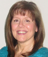 A smiling white woman with shoulder length hair