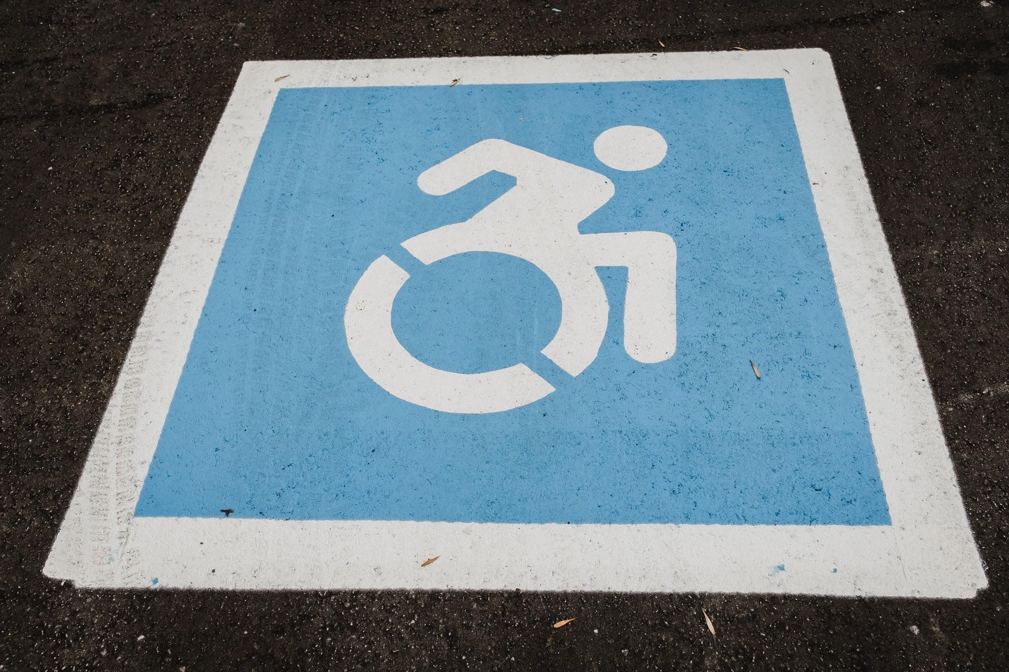 A symbol of a wheelchair user in an accessible parking space